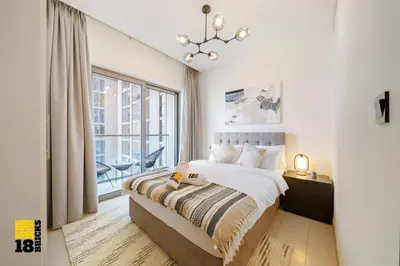 a bedroom with a bed and a large window at Sleek One Bed Sobha Creek Vistas Reserve Tower A in Dubai