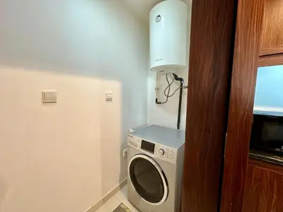 a washer and dryer in a small room at Lux BnB I The Residences I Sky Line Views in Dubai