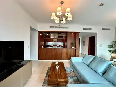 a living room with a blue couch and a coffee table at Lux BnB I The Residences I Sky Line Views in Dubai