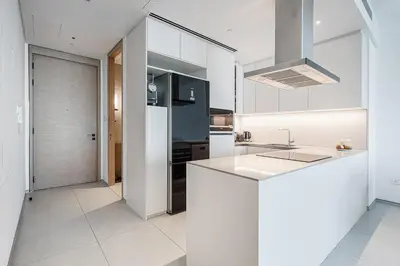 a kitchen with white cabinets and a white counter top at Manzil - 2BR Apartment in The Address JBR with Private Beach Access & Dubai Eye View in Dubai