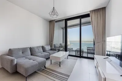 a living room with a couch and a table at Manzil - 2BR Apartment in The Address JBR with Private Beach Access & Dubai Eye View in Dubai
