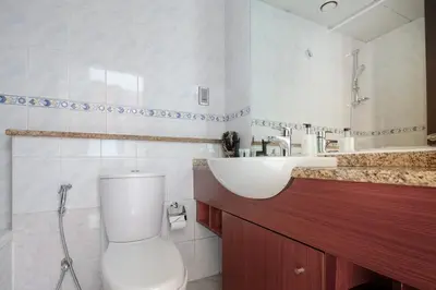 a bathroom with a toilet and a sink at Frank Porter - Lake View Tower in Dubai