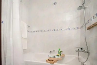 a bathroom with a shower and a tub and a sink at Frank Porter - Lake View Tower in Dubai