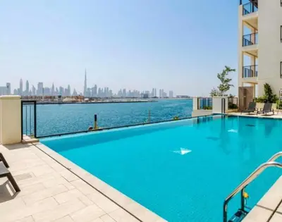 a large swimming pool with a view of the city at Ocean Majestic Full Sea View at Le Pont in Dubai