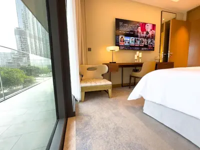 a bedroom with a bed and a desk and a window at The Address Residences Dubai Opera, Full Burj Khalifa View, Luxurious 2BR in Dubai