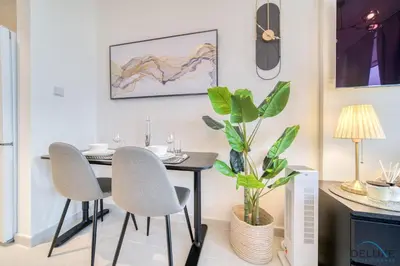 a dining room with a table and two chairs at Appealing Studio at Carson C DAMAC Hills Dubailand by Deluxe Holiday Homes in Dubai