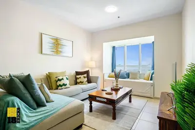 a living room with a couch and a table at Lux Sea view 1BR in Dubai Marina in Dubai