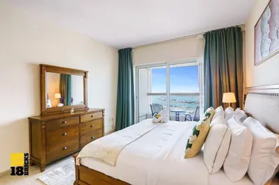 a bedroom with a large bed with a large window at Lux Sea view 1BR in Dubai Marina in Dubai
