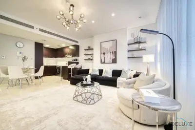 a living room with a couch and a table at Limited Time Offer Stylish 1BR near to Metro by Deluxe Holiday Homes in Dubai