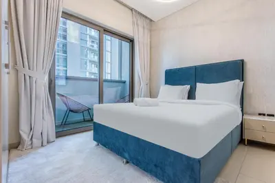 a bedroom with a large bed and a large window at STAY BY LATINEM Luxury 1BR Holiday Home CVR B1701 near Burj Khalifa in Dubai