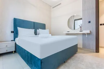 a bedroom with a large bed and a mirror at STAY BY LATINEM Luxury 1BR Holiday Home CVR B1701 near Burj Khalifa in Dubai