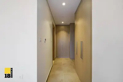 a hallway with doors and a tile floor and a corridor at Brand New 2BR in Creek Harbour in Dubai