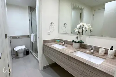 a bathroom with two sinks and a large mirror at Oraya - Suburban Serenity at Spacious 4BR Villa in Maple 2 in Dubai
