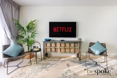 a living room with a television on a wall at Bespoke Holiday Homes - Palm Jumeirah -2 Bedroom Sea View with Beach Access, Balqis in Dubai