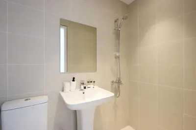 a bathroom with a sink and a toilet and a mirror at Livbnb - Bluewaters 3BR plus Maid's, with Sea Views in Dubai