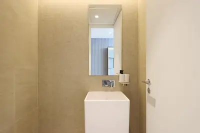 a bathroom with a sink and a mirror at Livbnb - Bluewaters 3BR plus Maid's, with Sea Views in Dubai