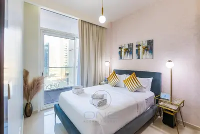 a bedroom with a large bed and a large window at Burj View Apartment at Vera, Business Bay in Dubai