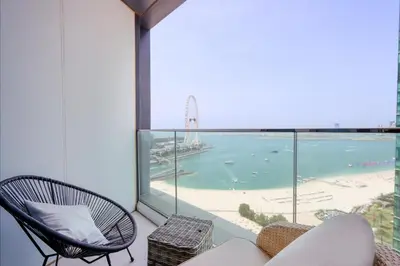 a living room with a view of a beach and the ocean at Livbnb Premium 3BR at Address JBR Posh Interiors with Sea and Ain Views in Dubai