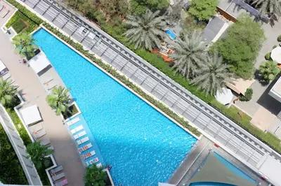 an overhead view of a large swimming pool with palm trees at Livbnb Premium 3BR at Address JBR Posh Interiors with Sea and Ain Views in Dubai