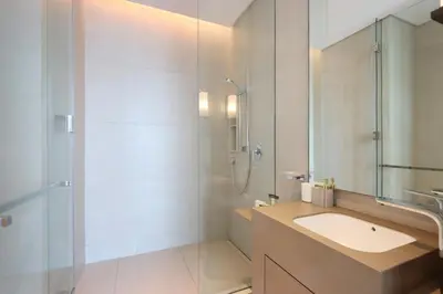 a white bathroom with a sink and a shower at Livbnb Premium 3BR at Address JBR Posh Interiors with Sea and Ain Views in Dubai