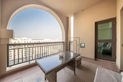 a balcony with a table and a view of a city at Stylish Urban Retreat 1BR Gem Fairmont Residence - 90AB2 in Dubai