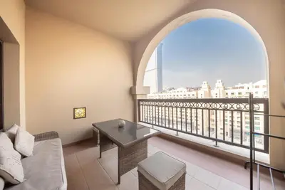 a living room with a couch and a balcony at Stylish Urban Retreat 1BR Gem Fairmont Residence - 90AB2 in Dubai