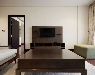 a living room with a tv and a coffee table at Authentic 2 bdr in Anantara Resort Palm Jumeirah in Dubai