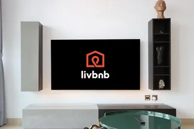 a living room with a tv on a wall at Livbnb Elegant 3BR in Marina Gate Panoramic Marina Views with Private Balcony in Dubai