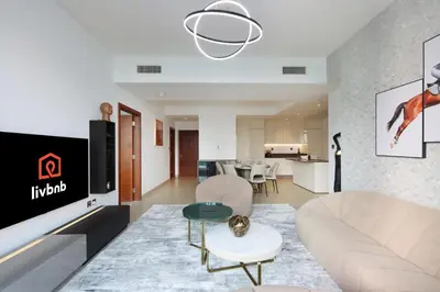 a living room with a couch and a table at Livbnb Elegant 3BR in Marina Gate Panoramic Marina Views with Private Balcony in Dubai