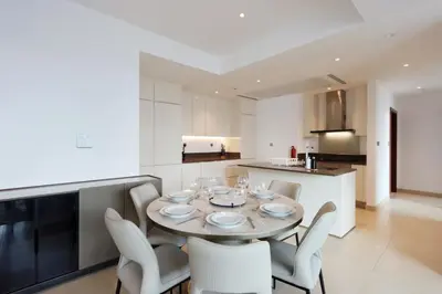 a kitchen and dining room with a table and chairs at Livbnb Elegant 3BR in Marina Gate Panoramic Marina Views with Private Balcony in Dubai