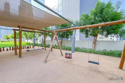 an empty playground with swings in a building at Stylish 2BR with Burj Khalifa View at Burj Royale Downtown Dubai by Deluxe Holiday Homes in Dubai