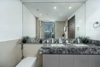 a bathroom with two sinks and a large mirror at Spacious and Overlooking Burj & Fountains in Dubai