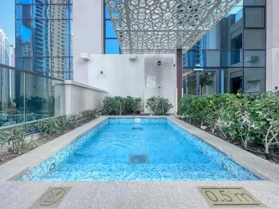 a swimming pool in the middle of a building at Spacious and Overlooking Burj & Fountains in Dubai