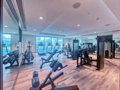 a gym with a bunch of treadmills and exercise bikes at Spacious and Overlooking Burj & Fountains in Dubai