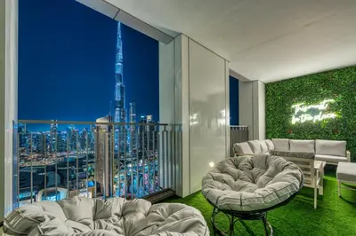 a living room with a view of a city at Dubai Mall Connection - Burj Views - Turf Balcony in Dubai