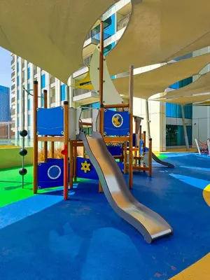 a playground with a slide in a building at Dubai Mall Connection - Burj Views - Turf Balcony in Dubai