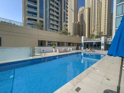 a large swimming pool in a city with tall buildings at NEW Listing - Czechin - JBR Beach a Few Steps Away in Dubai