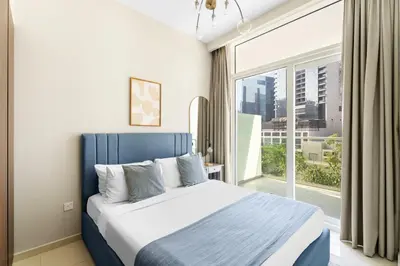 a bedroom with a bed and a large window at Aliving Exclusive 1BR Reva Residence Business Bay-218 in Dubai