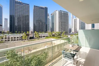 a balcony with a table and chairs and a city skyline at Aliving Exclusive 1BR Reva Residence Business Bay-218 in Dubai