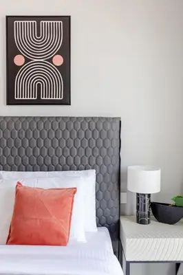 a bedroom with a bed with a headboard and a lamp at Frank Porter - Downtown Views II in Dubai