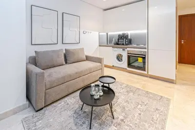 a living room with a couch and a table at Urban Elegance new studio near Dubai Mall & Burj in Dubai