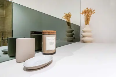 a white counter with a jar and a plate and a candle at Urban Elegance new studio near Dubai Mall & Burj in Dubai