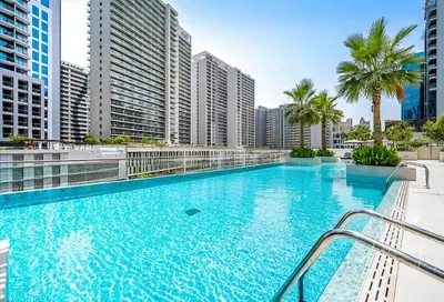 a large swimming pool in a city with tall buildings at Urban Elegance new studio near Dubai Mall & Burj in Dubai