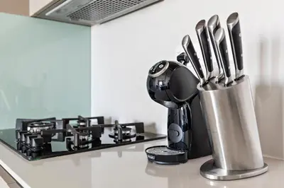 a kitchen counter with a container of utensils at StoneTree - Cozy 1 BR Apartment in Al Furjan in Dubai