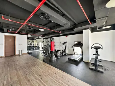 a gym with several treadmills and cardio machines at StoneTree - Cozy 1 BR Apartment in Al Furjan in Dubai