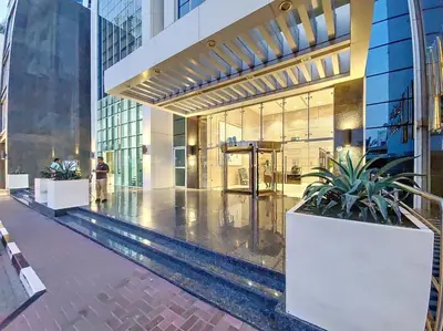 a building with a pool in the middle of it at Marina Arcade - Neat Two Bedroom in Dubai
