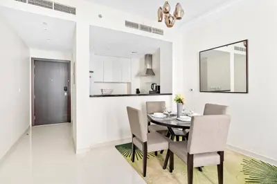 a dining room with a table and chairs at StoneTree - Furnished 1BR minutes of drive away to Expo 2020 in Dubai