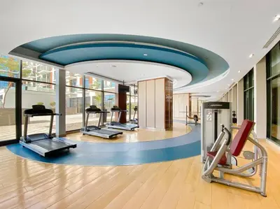 a gym with treadmills and ellipticals in a building at StoneTree - Furnished 1BR minutes of drive away to Expo 2020 in Dubai