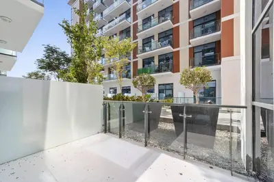 a balcony with a fence and a building at StoneTree - Furnished 1BR minutes of drive away to Expo 2020 in Dubai