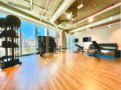 a gym with a hard wood floor and a large window at Downtown Views 1BR - Dubai Mall, Fountain & Burj Khalifa access in Dubai